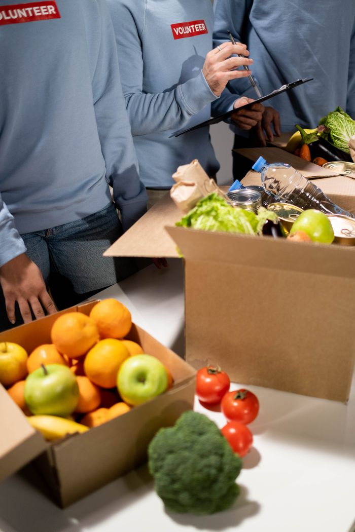 gallery-5 Energetic volunteers organize fresh fruits and vegetables for a community relief effort.